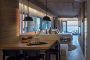 Venus Deluxe Suite A2 open-plan dining and bedroom with sunset sea view, Urban Suites Alimos Athens